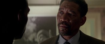 Movie still from “Kiss the Girls” (1997), directed by Gary Fleder – An older man in a suit and tie looking to his left; Close Up shot, Over the shoulder angle