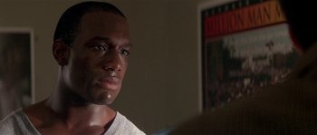 Movie still from “Kiss the Girls” (1997), directed by Gary Fleder – A person wearing a white t - shirt; Close Up shot, Over the shoulder angle