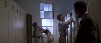 Movie still from “Kiss the Girls” (1997), directed by Gary Fleder – A group of men standing next to each other in a room; Medium shot, Low angle