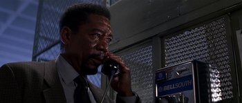 Movie still from “Kiss the Girls” (1997), directed by Gary Fleder – An older man talking on a phone while wearing a suit and tie; Close Up shot, Low angle