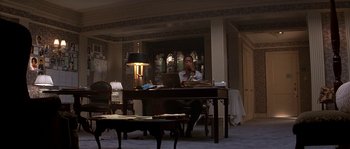 Movie still from “Kiss the Girls” (1997), directed by Gary Fleder – A man sitting at a table in front of an open laptop computer; Wide shot, High angle