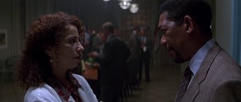 Movie still from “Kiss the Girls” (1997), directed by Gary Fleder – A woman and a man talking to each other in a room; Close Up shot, Over the shoulder angle