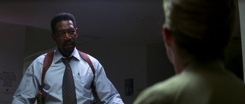 Movie still from “Kiss the Girls” (1997), directed by Gary Fleder – A man in a suit and tie talking to another man in a suit and tie; Medium shot, Low angle