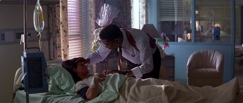Movie still from “Kiss the Girls” (1997), directed by Gary Fleder – A man in white shirt and a woman in white shirt in a room; Medium shot, Over the shoulder angle