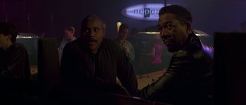 Movie still from “Kiss the Girls” (1997), directed by Gary Fleder – A group of men sitting in a room; Medium shot, Over the shoulder angle