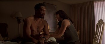 Movie still from “Kiss the Girls” (1997), directed by Gary Fleder – A man and a woman sitting on a bed; Medium shot, Low angle