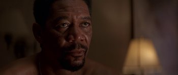 Movie still from “Kiss the Girls” (1997), directed by Gary Fleder – A man's face in a dark room; Close Up shot, Low angle