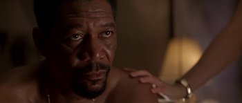 Movie still from “Kiss the Girls” (1997), directed by Gary Fleder – A man's face with a cigarette in his hand; Close Up shot, Low angle