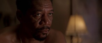 Movie still from “Kiss the Girls” (1997), directed by Gary Fleder – A man's face in a dark room; Close Up shot, Low angle