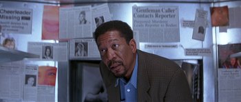 Movie still from “Kiss the Girls” (1997), directed by Gary Fleder – An older black man in a suit and blue shirt; Close Up shot, Over the shoulder angle