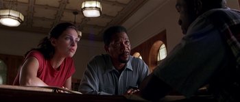 Movie still from “Kiss the Girls” (1997), directed by Gary Fleder – A man and a woman are looking at a laptop computer; Close Up shot, Low angle
