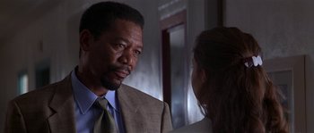 Movie still from “Kiss the Girls” (1997), directed by Gary Fleder – A man in a suit and tie talking to a woman in a suit; Close Up shot, Over the shoulder angle