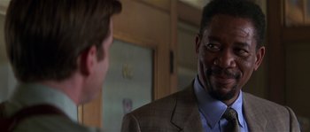 Movie still from “Kiss the Girls” (1997), directed by Gary Fleder – A man in a business suit talking to another man in a business suit; Close Up shot, Over the shoulder angle