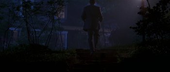 Movie still from “Kiss the Girls” (1997), directed by Gary Fleder – A man walking up steps in the dark; Wide shot, Low angle