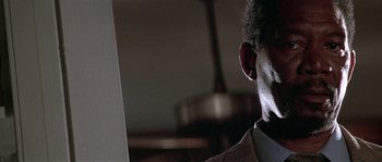 Movie still from “Kiss the Girls” (1997), directed by Gary Fleder – A man in a suit looking off into the distance; Close Up shot, Low angle
