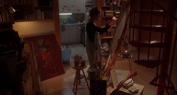 Movie still from “Kissing Jessica Stein” (2001), directed by Charles Herman-Wurmfeld – A woman is painting in her home studio; Wide shot, High angle