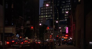 Movie still from “Kissing Jessica Stein” (2001), directed by Charles Herman-Wurmfeld – A busy city street at night lit up by street lights; Extreme Wide shot, Low angle