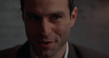 Movie still from “Kissing Jessica Stein” (2001), directed by Charles Herman-Wurmfeld – A man's face in a suit and tie; Close Up shot, Over the shoulder angle