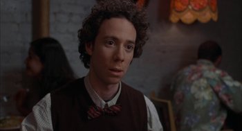 Movie still from “Kissing Jessica Stein” (2001), directed by Charles Herman-Wurmfeld – A man with curly hair wearing a bow tie; Close Up shot, Over the shoulder angle