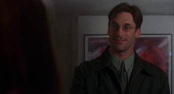 Movie still from “Kissing Jessica Stein” (2001), directed by Charles Herman-Wurmfeld – A person wearing glasses and a jacket; Close Up shot, Over the shoulder angle