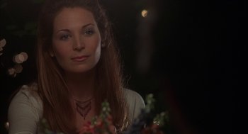 Movie still from “Kissing Jessica Stein” (2001), directed by Charles Herman-Wurmfeld – A beautiful woman sitting in front of a bunch of flowers; Close Up shot, Over the shoulder angle