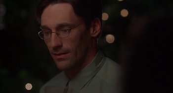 Movie still from “Kissing Jessica Stein” (2001), directed by Charles Herman-Wurmfeld – A person wearing glasses and a green shirt; Close Up shot, Over the shoulder angle
