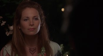 Movie still from “Kissing Jessica Stein” (2001), directed by Charles Herman-Wurmfeld – A woman with long red hair wearing a necklace; Close Up shot, Over the shoulder angle