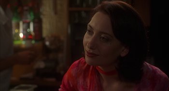 Movie still from “Kissing Jessica Stein” (2001), directed by Charles Herman-Wurmfeld – A woman in a red shirt is looking to her left; Close Up shot, Over the shoulder angle