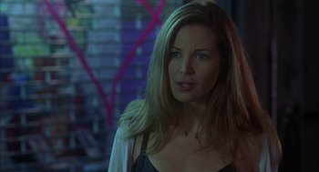 Movie still from “Kissing Jessica Stein” (2001), directed by Charles Herman-Wurmfeld – A woman with long blonde hair standing in a room; Close Up shot, Over the shoulder angle