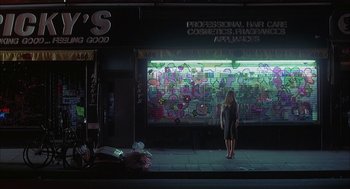 Movie still from “Kissing Jessica Stein” (2001), directed by Charles Herman-Wurmfeld – A woman standing on the sidewalk in front of a store; Wide shot, Over the shoulder angle