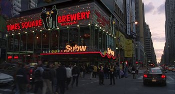 Movie still from “Kissing Jessica Stein” (2001), directed by Charles Herman-Wurmfeld – A group of people walking down a street near a building; Extreme Wide shot, High angle