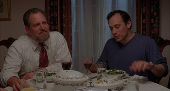 Movie still from “Kissing Jessica Stein” (2001), directed by Charles Herman-Wurmfeld – Two men sitting at a dinner table drinking wine; Medium shot, Over the shoulder angle