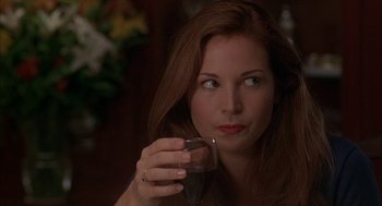 Movie still from “Kissing Jessica Stein” (2001), directed by Charles Herman-Wurmfeld – A beautiful woman holding a glass of wine; Close Up shot, Over the shoulder angle