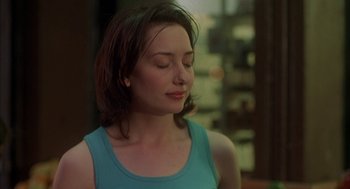 Movie still from “Kissing Jessica Stein” (2001), directed by Charles Herman-Wurmfeld – A woman with her eyes closed in a blue tank top; Close Up shot, Over the shoulder angle