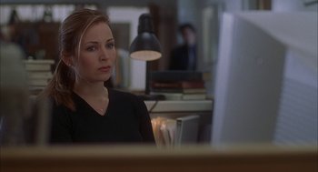 Movie still from “Kissing Jessica Stein” (2001), directed by Charles Herman-Wurmfeld – A woman sitting in front of a computer monitor in an office setting; Close Up shot, Over the shoulder angle