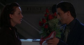 Movie still from “Kissing Jessica Stein” (2001), directed by Charles Herman-Wurmfeld – A man and a woman looking at each other's shoes; Close Up shot, High angle