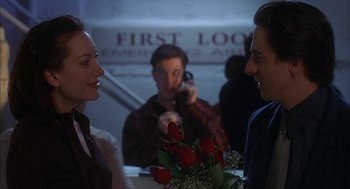 Movie still from “Kissing Jessica Stein” (2001), directed by Charles Herman-Wurmfeld – A man and a woman talking to each other in front of another man; Medium shot, Over the shoulder angle
