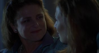 Movie still from “Kissing Jessica Stein” (2001), directed by Charles Herman-Wurmfeld – Two women sitting in front of each other and smiling; Close Up shot, Over the shoulder angle