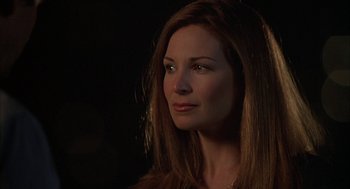 Movie still from “Kissing Jessica Stein” (2001), directed by Charles Herman-Wurmfeld – A woman with long red hair looking to her left; Close Up shot, Over the shoulder angle
