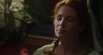 Movie still from “Kissing Jessica Stein” (2001), directed by Charles Herman-Wurmfeld – A woman with her eyes closed and her hair in a ponytail; Close Up shot, Low angle
