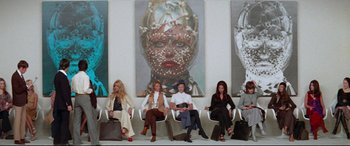 Movie still from “Klute” (1971), directed by Alan J. Pakula – A group of women sitting in chairs in front of a painting; Wide shot, Low angle