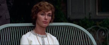 Movie still from “Klute” (1971), directed by Alan J. Pakula – A person sitting on a chair; Close Up shot, Over the shoulder angle