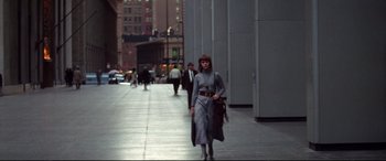 Movie still from “Klute” (1971), directed by Alan J. Pakula – A woman walking down the street with a purse; Wide shot, Low angle