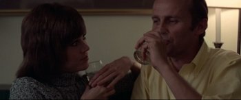 Movie still from “Klute” (1971), directed by Alan J. Pakula – A man and a woman are drinking wine; Close Up shot, Over the shoulder angle