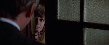 Movie still from “Klute” (1971), directed by Alan J. Pakula – A person looking at a mirror; Close Up shot, Over the shoulder angle