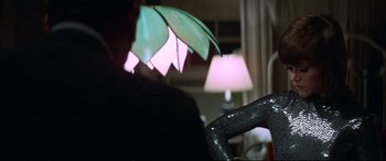 Movie still from “Klute” (1971), directed by Alan J. Pakula – A person holding an open umbrella; Medium shot, Over the shoulder angle
