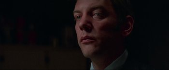 Movie still from “Klute” (1971), directed by Alan J. Pakula – A man's face in the dark; Close Up shot, Low angle