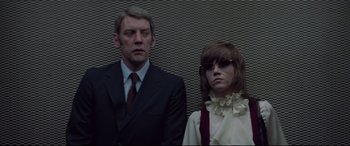 Movie still from “Klute” (1971), directed by Alan J. Pakula – A man and a woman standing next to each other; Medium shot, Low angle