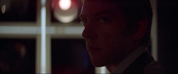 Movie still from “Klute” (1971), directed by Alan J. Pakula – A man's face in the dark; Extreme Close Up shot, Low angle