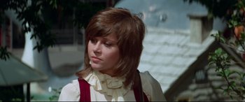 Movie still from “Klute” (1971), directed by Alan J. Pakula – A young woman with brown hair wearing a white blouse; Close Up shot, Low angle